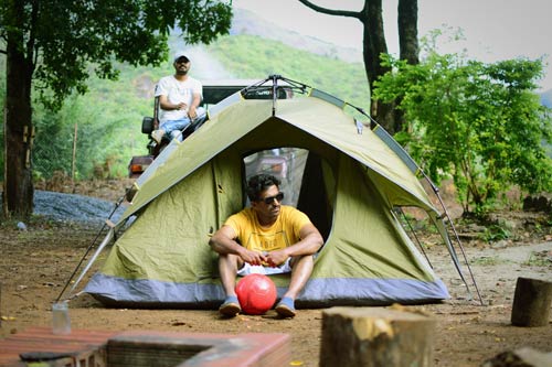 men in tent camping