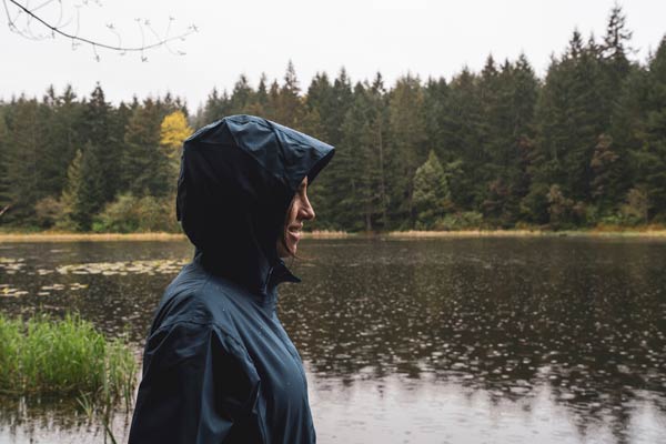 person in raincoat while camping