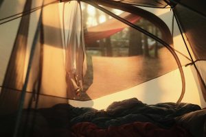unsplash photo from the inside of a tent with the door drawn